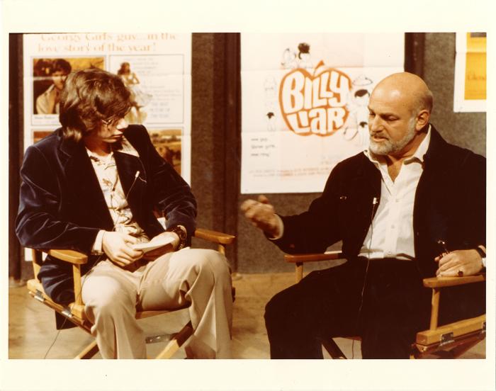 Photographic Materials depicts: two men in director's chairs, talking