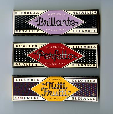 Three-Dimensional Objects, Packaging depicts: Three black boxes with polka dots. each box has a different colored diamond shaped label and product name, one with a purple "Brillante" one with a red "Perfetto" and one with a yellow "Tuttu-Frutti"