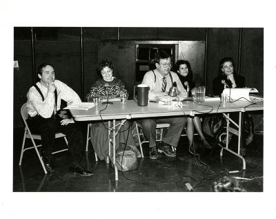 Photographic Materials depicts: Five people with microphones at a table.