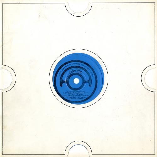 Serial Publications depicts: white record sleeve with die-cut circle for blue flexi disk inside