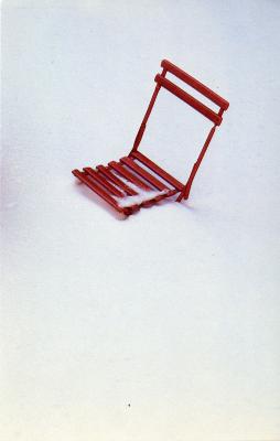 Cards depicts: A red folding chair sticking out of the snow 
