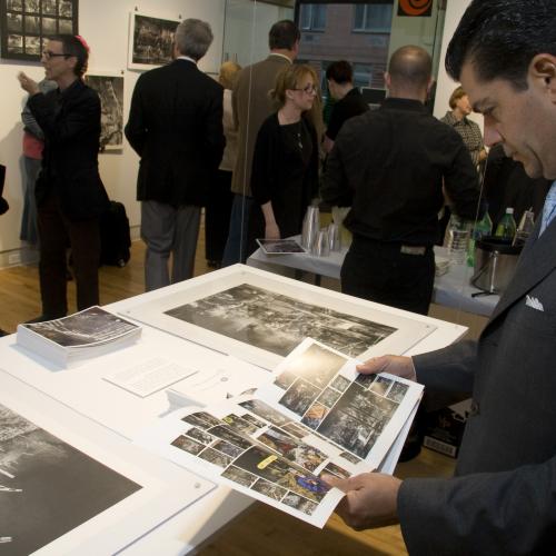 Digital Files, Photographic Materials depicts: People looking at hung artworks at opening reception