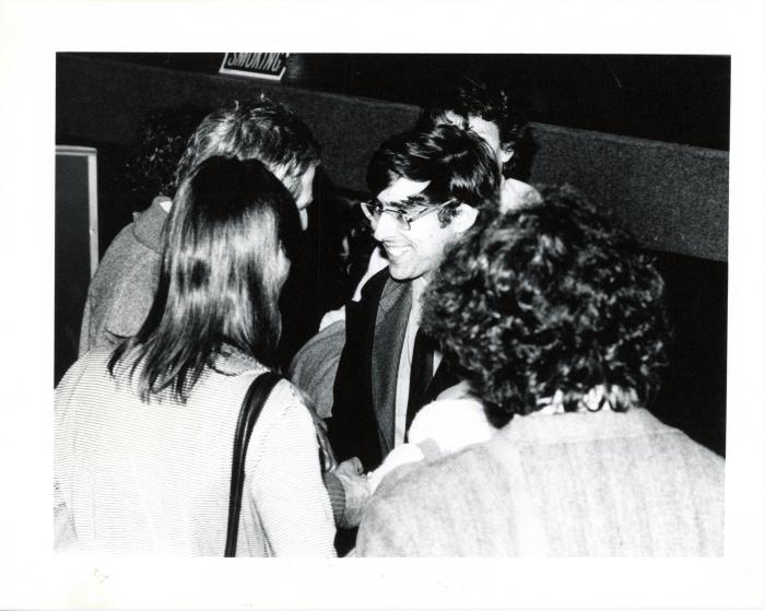 Photographic Materials depicts: blakc and black and white photograph of david shapiro speaking with members of the audience