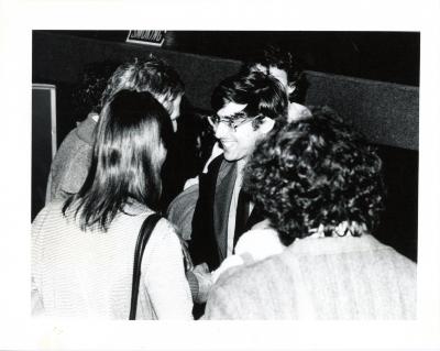 Photographic Materials depicts: blakc and black and white photograph of david shapiro speaking with members of the audience