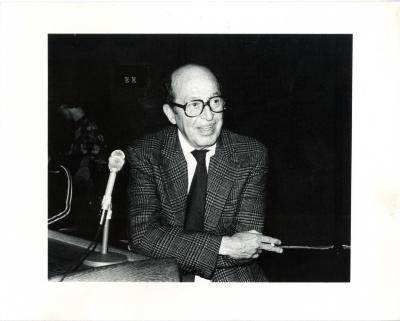 Photographic Materials depicts: balding man in a suit holding a cigarette