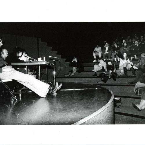 Photographic Materials depicts: black and white photograph of panel and audience