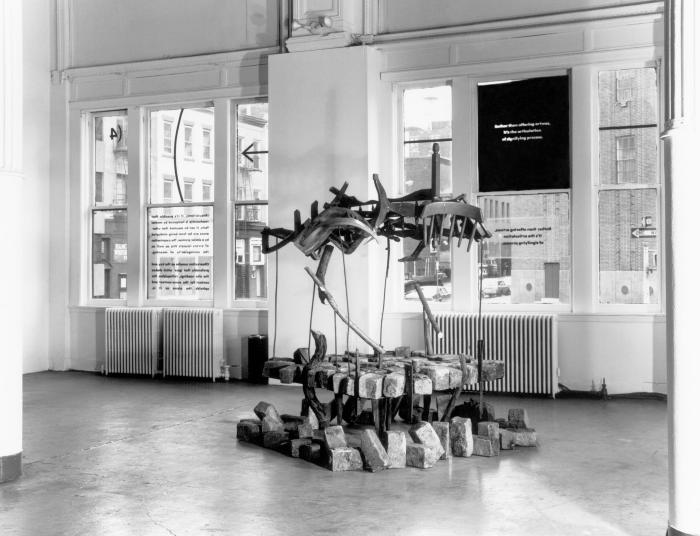Photographic Materials depicts: black-and-white photographic prints of artworks installed in a gallery