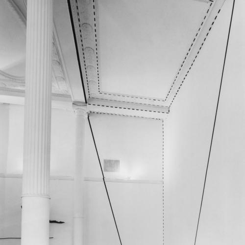 Photographic Materials depicts: black and white photographic print of artworks in a gallery